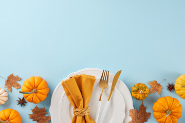 Form a Thanksgiving table that makes an impression. Top view photo of plates, cutlery, pumpkins,...