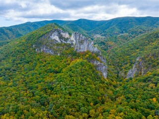 Aerial view of the Seneca Rocks with lush vegetation and clouds