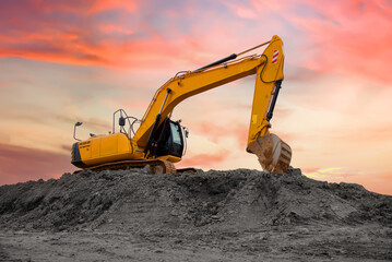 Track-type excavator during earthmoving at construction site. Backhoe digging the ground for the...