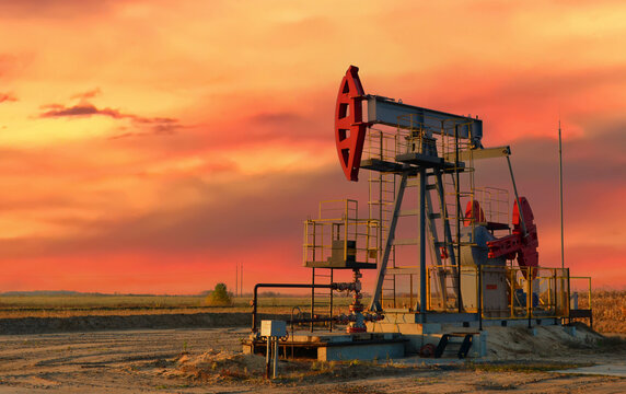 Oil prices on global market. Crude oil Pumpjack on oilfield on sunset. Fossil crude production. Oil drill rig and drilling derrick. Global crude oil Prices, petroleum demand OPEC+. Pump jack, oilfield