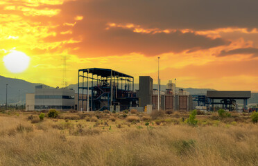 Fototapeta na wymiar Natural gas transmission station in Spain. Spanish Gas System in Sagunto. Chemical factory. Natural gas production and Crude oil solution. Chimney smokestack emission. Gas Processing Plant on sunset.