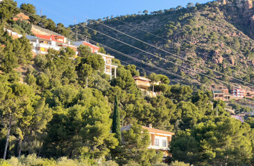 Villa in mountains in El Picaio, Puçol, Sagunto, Valencia, Spain. Mountains landscape, nature scenery. Towhouse and Home on hills. House in mountains. Rural landscape with hills. Houses on Mountai