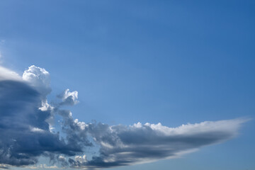 Fototapeta na wymiar clouds in the blue sky in summer over the black sea beach
