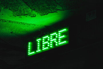 illuminated green traffic sign for free parking in indoor parking