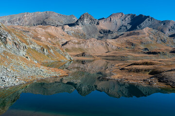 Leita lake with water reflection, Rosset, Leynir, Bes, Taou Blanc mountains peak. Gran Paradiso...