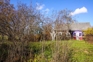Obraz premium Scenic nature view. Autumn landscape with rural house in Latvia.