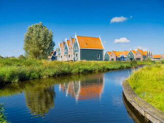 Naklejka na ściany i meble A row of houses in the Volendam, Netherlands. Old buildings. Architecture and construction. Photo for background and wallpaper.