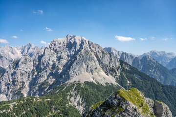 Fototapeta na wymiar Vrsic Pass and Prisojnik, or Prisank, Mountain. Sunny day in Julian Alps, Slovenia