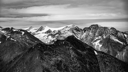 Majestic alpine panorama with glacier mountain of Grossvenediger. The main peak of the Venediger Group in Hohe Tauern mountain range. Austrian Alps, Austria. Black and white photography.