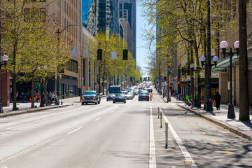 Street view of 4th Avenue, a commercial street of shops and restaurants through the city center of downtown Seattle, Washington.