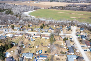 Capture the winter wonder of Barrie, Ontario, Canada, through this stunning drone photograph. Showcasing frozen lakes, dried-out trees, and grass, the image highlights the seasonal beauty of the area