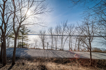 Embrace the serene beauty of Lake Simcoe in winter with this stunning image of its frozen surface. A symbol of the season's quietude and majestic charm, this picture is perfect for themes of Canadian 