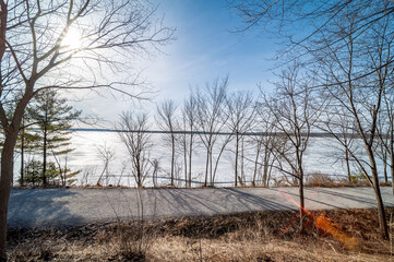 Embrace the serene beauty of Lake Simcoe in winter with this stunning image of its frozen surface. A symbol of the season's quietude and majestic charm, this picture is perfect for themes of Canadian 