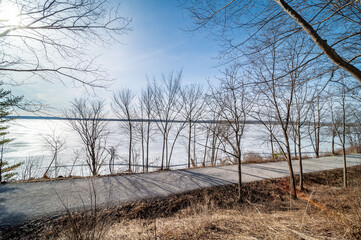 Embrace the serene beauty of Lake Simcoe in winter with this stunning image of its frozen surface. A symbol of the season's quietude and majestic charm, this picture is perfect for themes of Canadian 