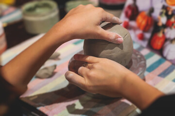 Pottery lesson master class for kids children, process of making clay pot on pottery wheel, potter hands creating ceramic crockery handcrafts, ceramist molding and painting jar or vase