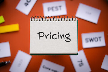 There is notebook with the word Pricing. It is as an eye-catching image.