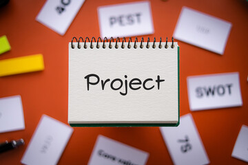 There is notebook with the word Project. It is as an eye-catching image.