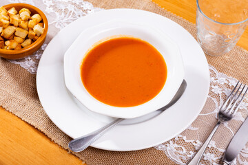 Healthy delicious lunch. Dietary creamy carrot soup blended to velvety-smooth consistency garnished...