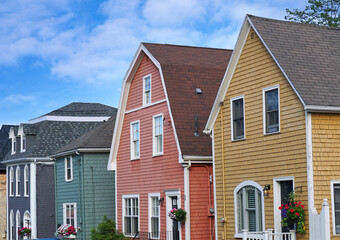 Row of colorful wooden clapboard houses - 663011289