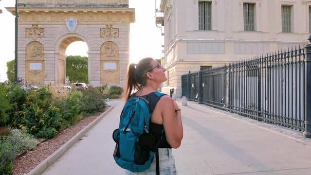 A tourist photographing the historic courthouse of Montpellier in France