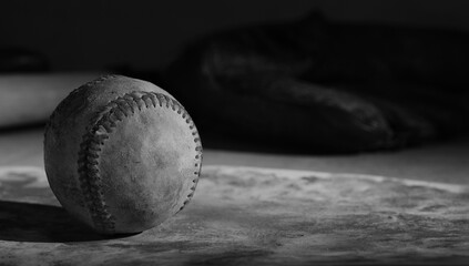 Baseball used in game shows old grunge texture in black and white with copy space on background.