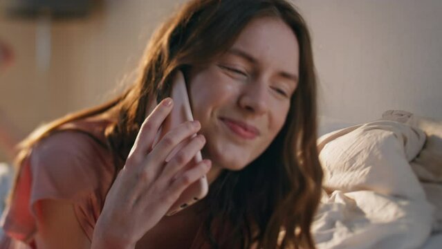 Attractive woman talking cell in sunlight closeup. Smiling girl hang up call