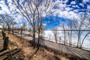 Revel in the pure simplicity of blue skies punctuated by wisps of clouds, captured in this...