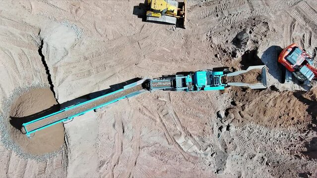 Conveying crushed type rock crusher output in an open pit mining quarry