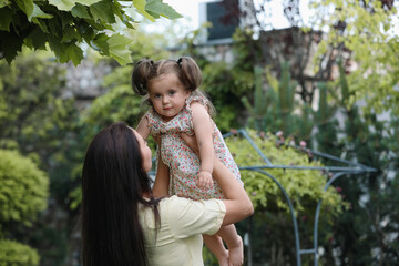Obraz premium Mother with her cute daughter spending time together in park