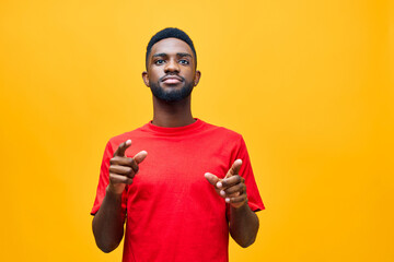 Happy young African American gen z guy isolated on beige background. Smiling hipster ethnic teen student, cool curly ethnic generation z teenager fashion model standing looking at camera, portrait.