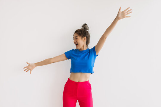 Happy And Cheerful Asian Woman With Wide Arms Open Isolated On White.