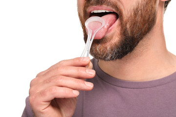 Man brushing his tongue with cleaner on white background, closeup