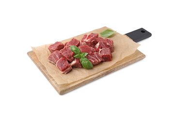 Wooden board with cut fresh beef meat and basil leaves isolated on white