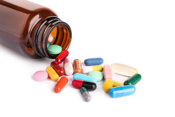 Plastic medical bottle with many different pills isolated on white