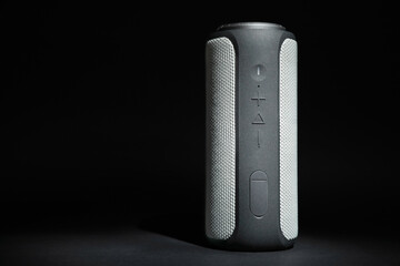 One portable bluetooth speaker on black background, space for text. Audio equipment