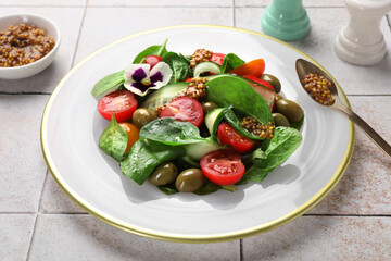 Delicious salad with vegetables, olives and grain mustard on light table, closeup