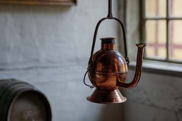 Selective focus at hanging vintage copper kettle at Den Gamle By.