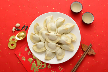 Delicious dumplings on a red background in China. The Chinese meaning in the picture is: attracting wealth and treasures