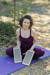 Woman holding sadhu boards in her hands. Teacher of standing on the sadhu board