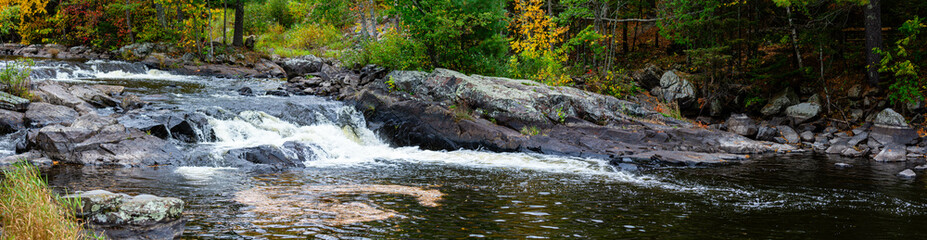 Obraz premium Waterfalls flowing into Lake of the Falls in Mercer, Wisconsin in September