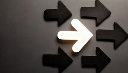 Obraz premium Arrow symbol glowing amid black arrow symbols on background.