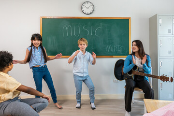 Group of student learn with teacher in classroom at elementary school. 