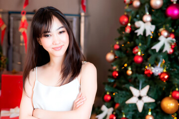 Christmas portrait of a Japanese woman in a white blouse with her arms folded