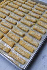 Rows of Indonesian cakes called kastangel on a table ready to bake