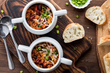 Bowls of homemade turkey chili served with crusty bread.