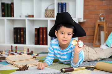 Cute little pirate with compass at home