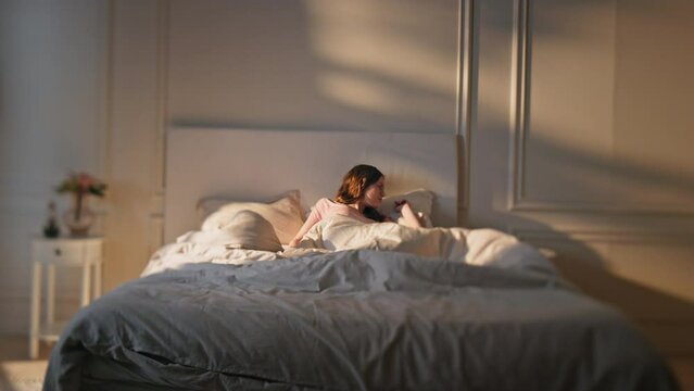 Late girl oversleep home in morning. Shocked woman wake up make smartphone call