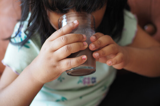 Child Drinking Tasty Chocolate Milk At Home.