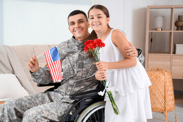 Soldier in wheelchair with USA flag and his little daughter at home. Veterans Day celebration