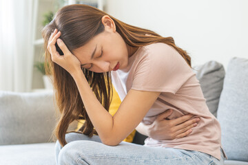 Flatulence asian young woman intolerance hand in stomach ache, suffer from food poisoning,...